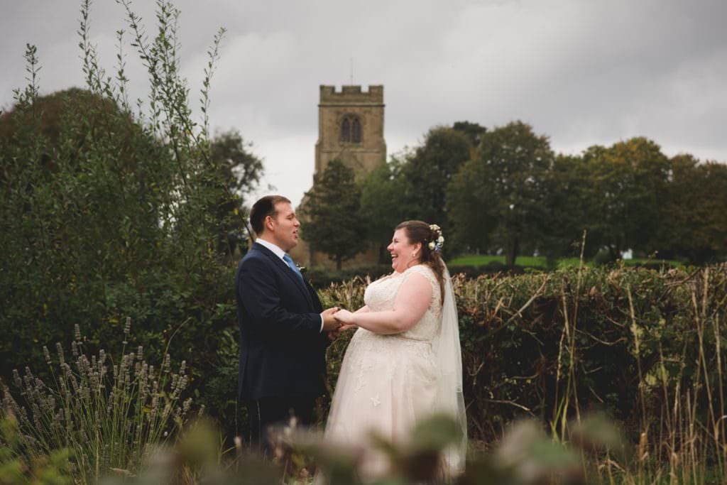 Bride and groom outside rock village hall