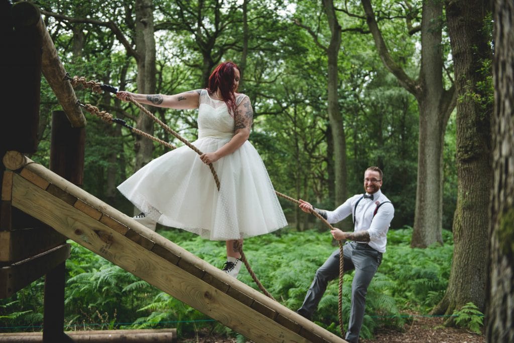 Enchanting Woodland Wedding Photography . Bride & groom on assault course
