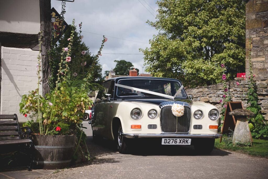 Fleece Inn Wedding Photography of vintage car parked outside the barn
