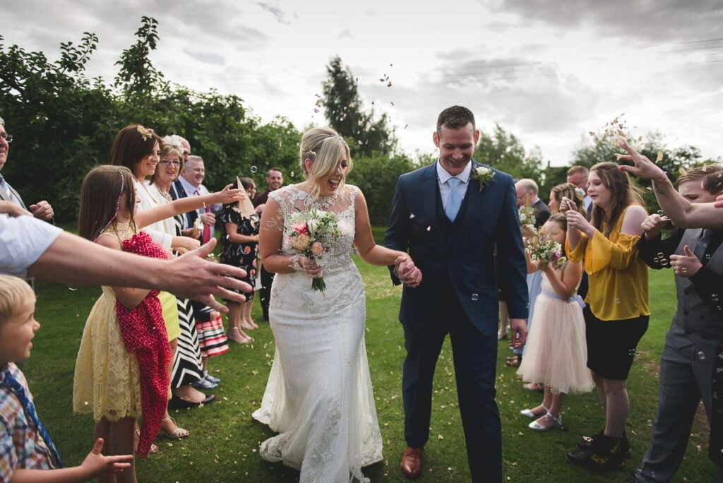 Fleece Inn Wedding Photography guests throwing confetti in the beer garden