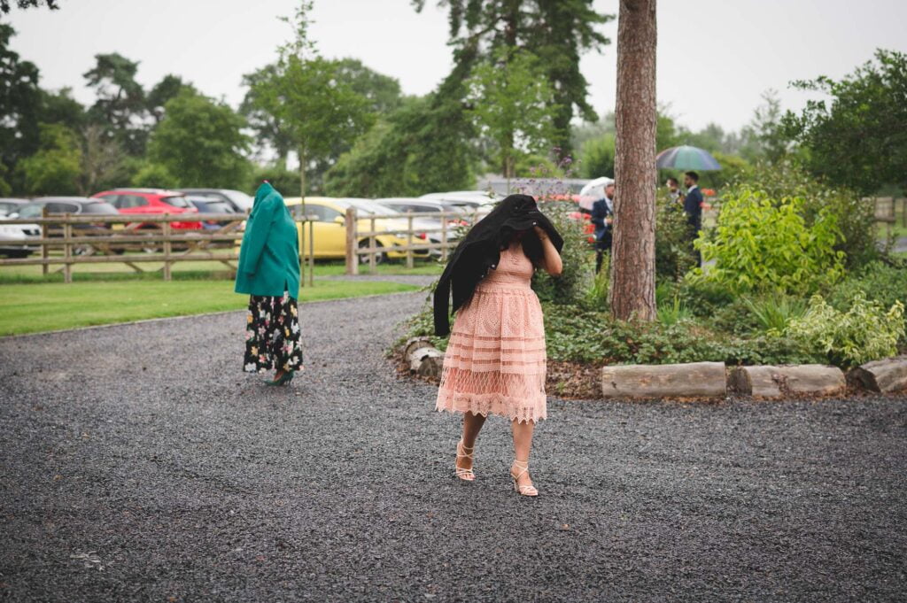 Barns & Yard Wedding Photography of guests arriving in the rain