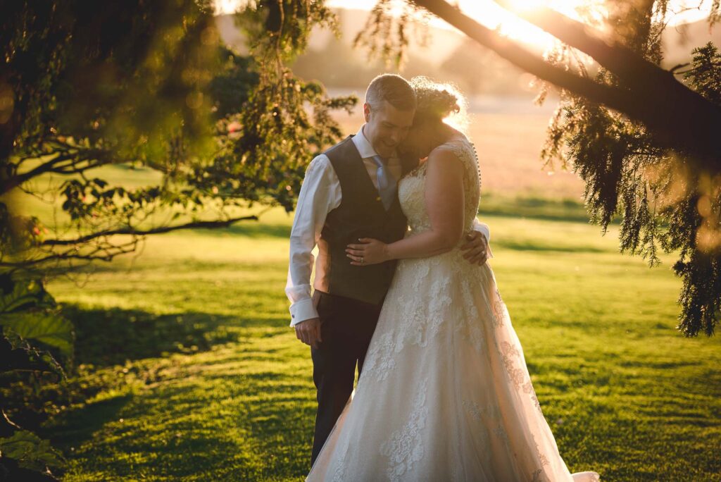 Birtsmorton Court Wedding Photography - couple walking in the evening light